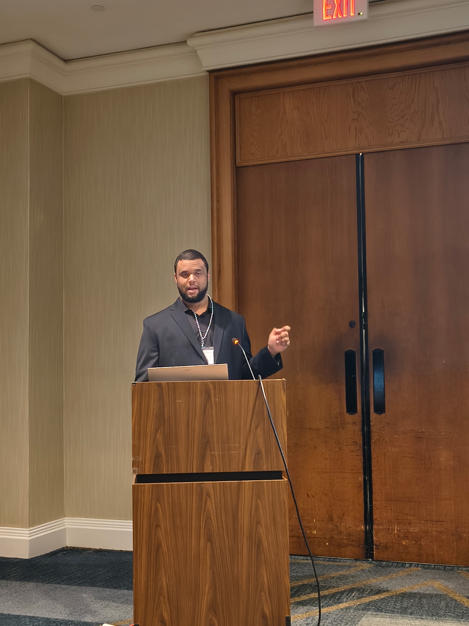 Tony Kinchen presenting his research at a conference podium